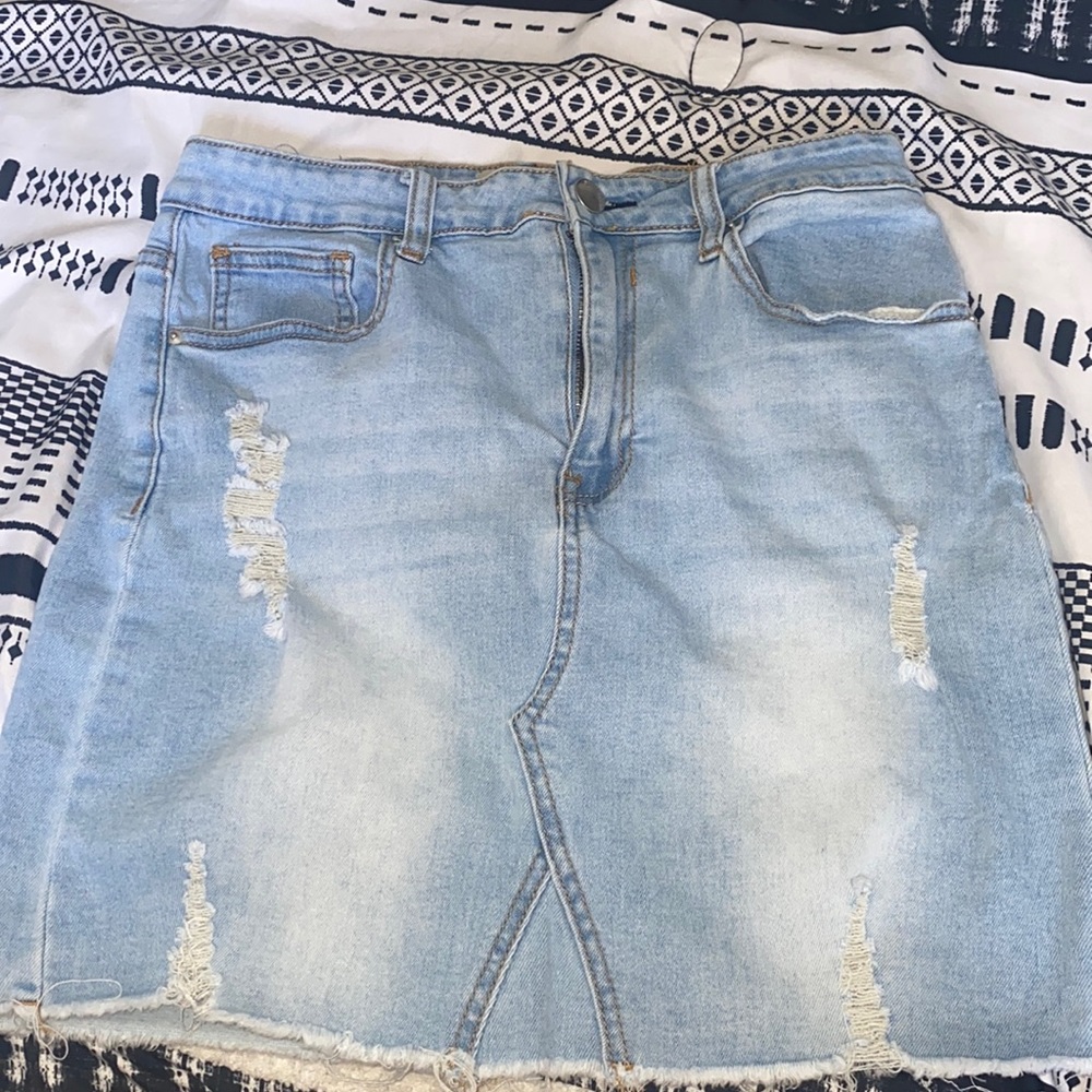 Light wash denim skirt with rips